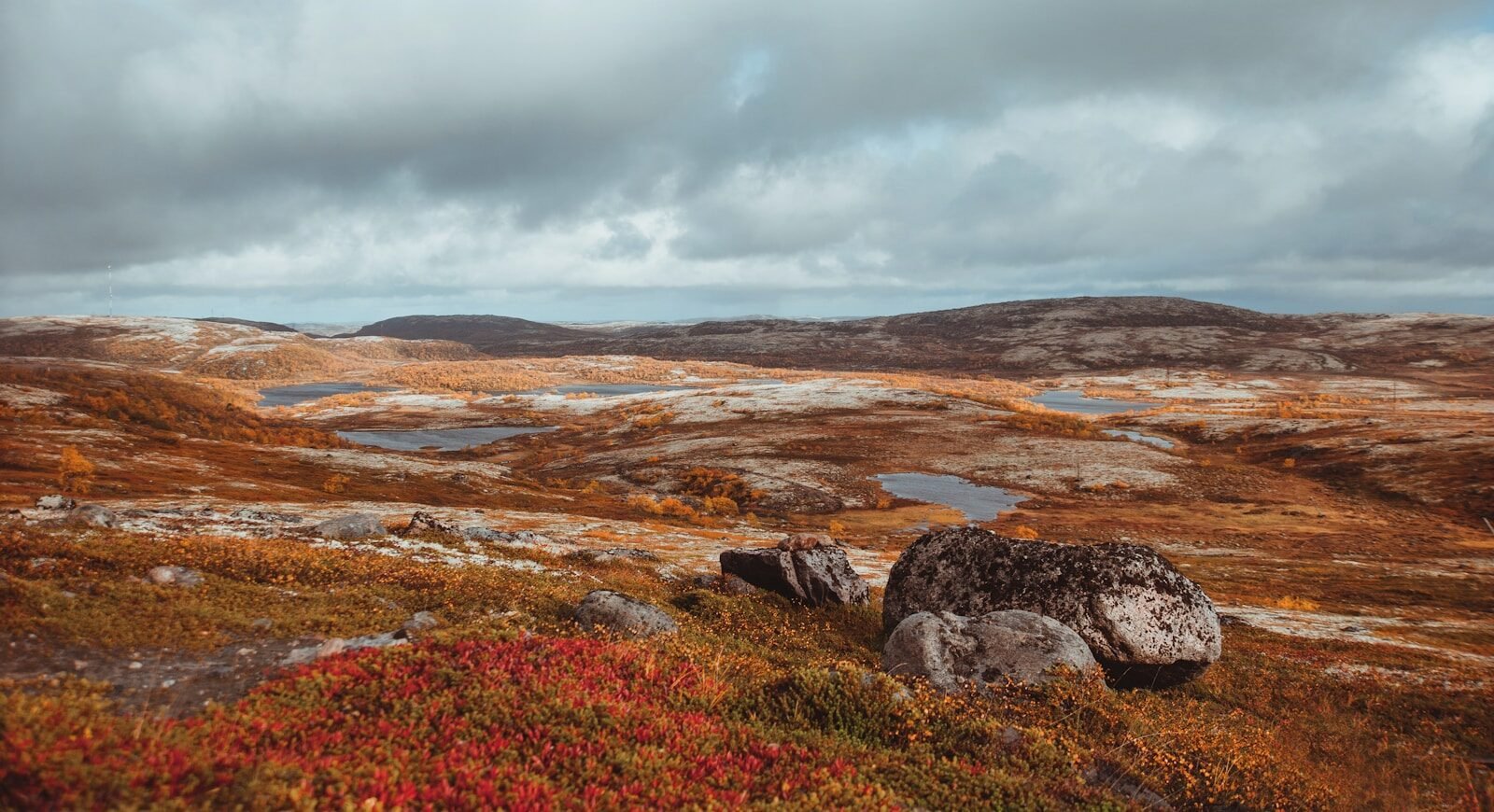 a rocky landscape with a body of water in the distance